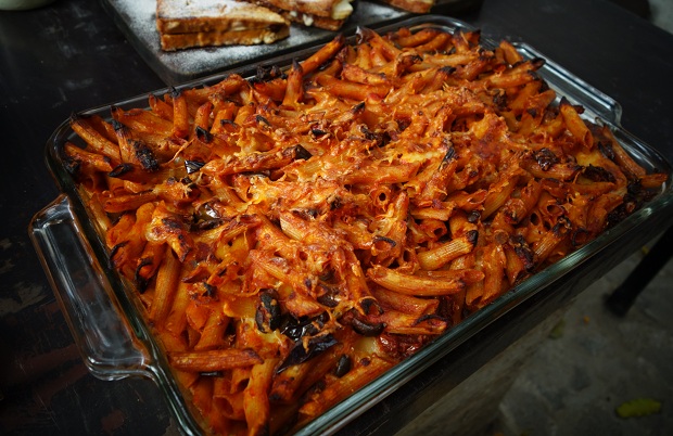 David Rocco Dolce India Pasta Al Forno in a baking dish with tomato sauce, eggplant, and mozzarella, scamorza cheeses mixed together with a sprinkle of Parmigiano cheese