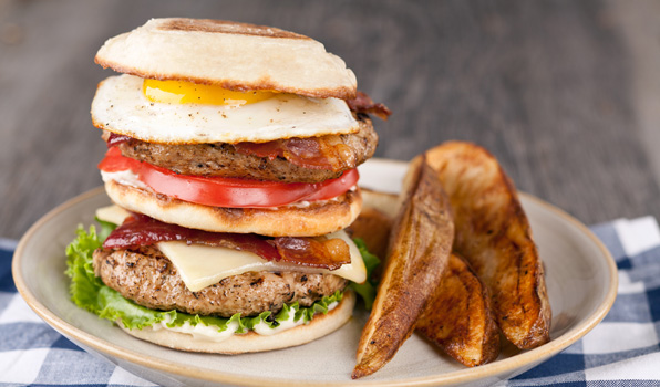 in the kitchen with stefano faita stefano's breakfast burger served on a plate with a side of baked fries