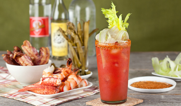 in the kitchen with stefano faita horseradish bloody mary garnished with shaved celery and served with shrimp, lobster, bacon and pickled green beans