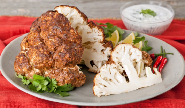 in the kitchen with stefano faita tandoori whole roasted cauliflower on a plate with tandoori paste on the side