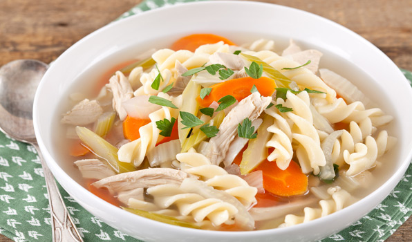 in the kitchen with stefano faita chicken noodle soup in a white bowl