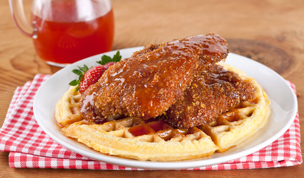 in the kitchen with stefano faita chicken and waffles with spicy maple syrup and strawberries as garnish