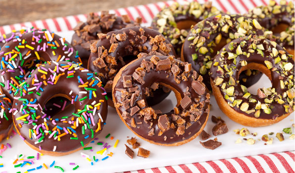 in the kitchen with stefano faita chocolate glazed donuts finished with sprinkles, nuts, toffee bits or shredded coconut.