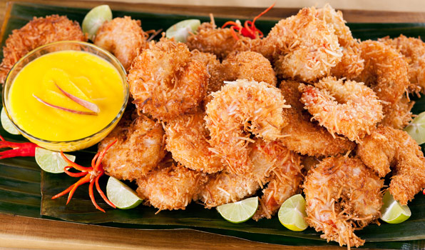 in the kitchen with stefano faita coconut shrimp with mango and ginger dipping sauce garnished with lime slices and chili peppers