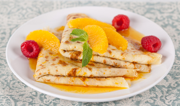 in the kitchen with stefano faita Crêpes Suzette drizzled with orange liqueur and garnished with orange segments and raspberries