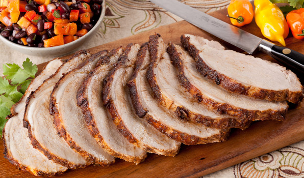 in the kitchen with stefano faita cuban style pork roast with papaya black bean salsa on a wood cutting board