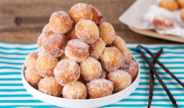 in the kitchen with stefano faita vanilla sugar donut holes piled on a white dish with vanilla beans on the side
