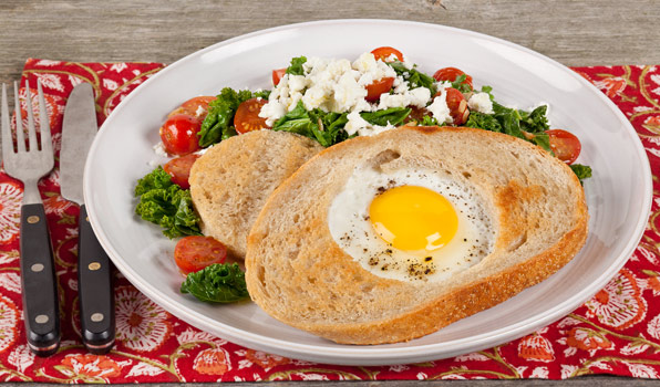 in the kitchen with stefano faita egg in the hole of bread slice served with a side of kale and cherry tomato sautée