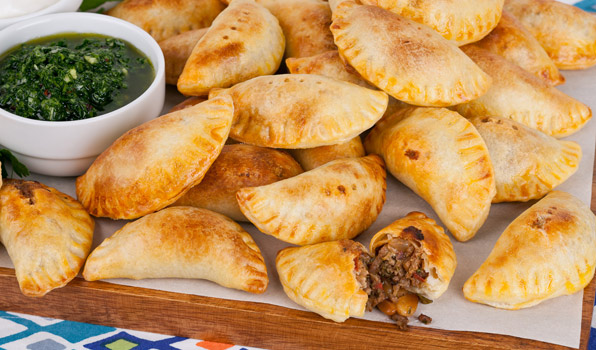 in the kitchen with stefano faita empanada bites served with Parsley Chimichurri and sour cream for dipping