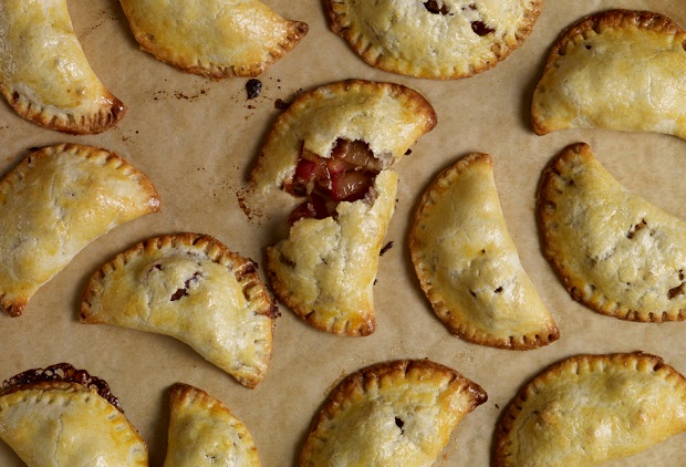 pati's mexican table five spice pecan plum empanadas displayed on baking sheet