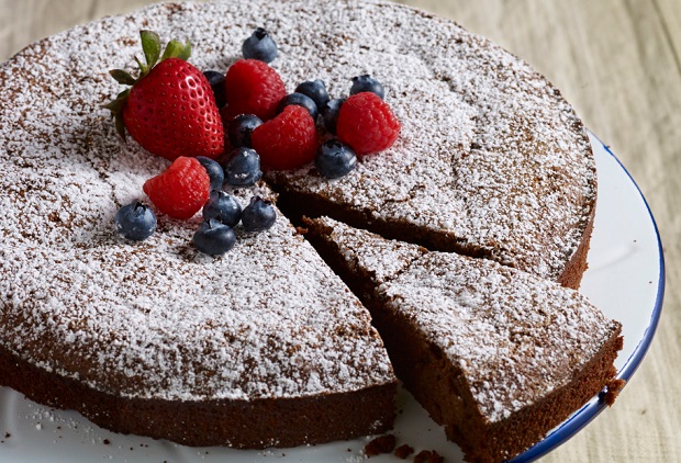 pati's mexican table nana jose's flourless chocolate pecan cake garnished with mixed berries and powdered sugar