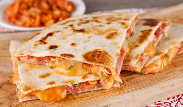 in the kitchen with stefano faita sweet and spicy ham quesadilla on a wooden board, served with kimchi on the side