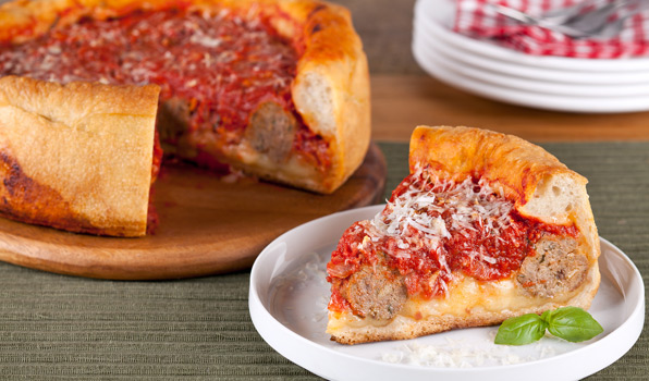 in the kitchen with stefano faita stefano's deep dish meatball pizza with a slice served on a dish with a sprig of basil