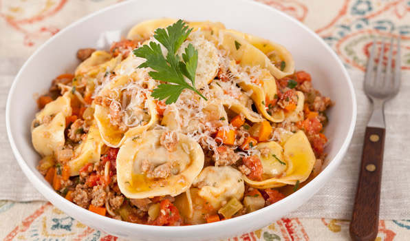 in the kitchen with stefano faita meat and cheese stuffed tortelloni in a white bowl with a fork