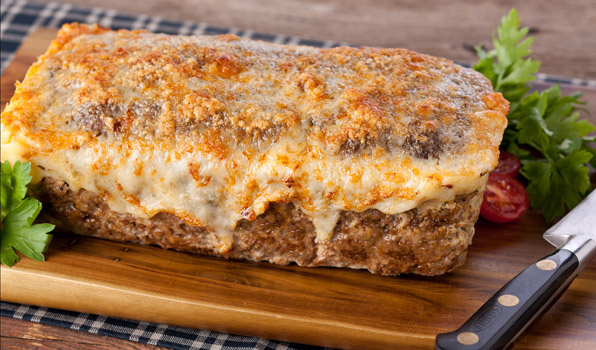 in the kitchen with stefano faita cheesy 3 meat meatloaf served on wooden cutting board