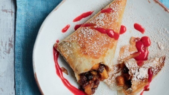 gino's italian escape no bake apple, raisin and amaretto strudel on plate with raspberry sauce drizzled over