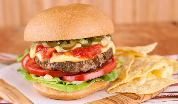 in the kitchen with stefano faita nacho cheese burger served on wooden platter with a side of tortilla chips