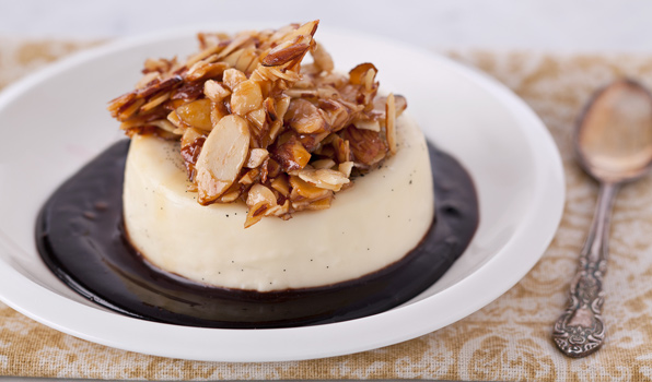 in the kitchen with stefano faita almond panna cotta with chocolate sauce topped with a cluster of candied almonds