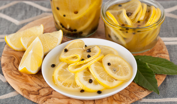 in the kitchen with stefano faita preserved lemons sliced thinly on a plate and jar and topped with peppercorns