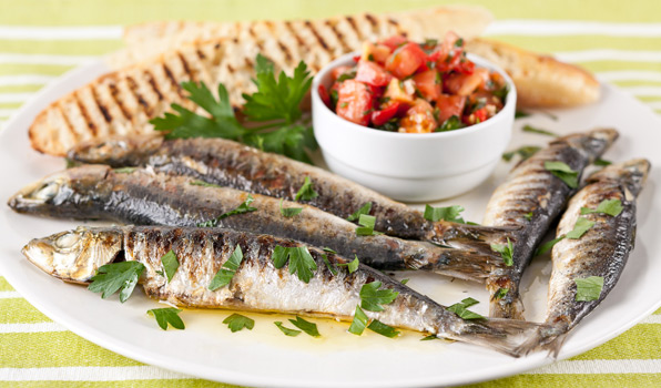 in the kitchen with stefano faita grilled sardines with italian salsa on a plate garnished with parsley