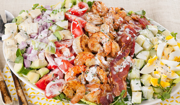 in the kitchen with stefano faita grilled shrimp and cobb salad on a plate