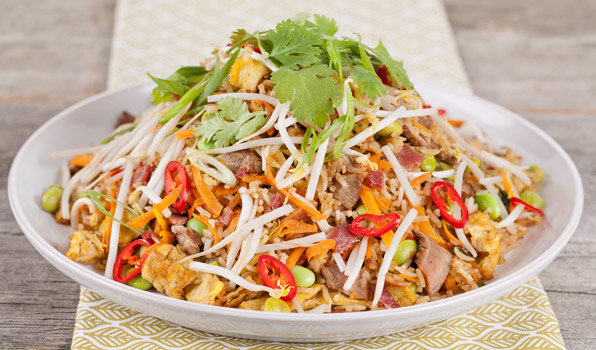 in the kitchen with stefano faita steak fried rice garnished with green onions, cilantro and bean sprouts