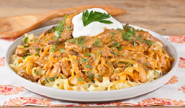 in the kitchen with stefano faita beef stroganoff served over buttered egg noodles and topped with sour cream and a sprig of parsley