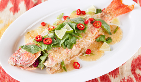 in the kitchen with stefano faita crispy thai fried snapper on a plate garnished with lime slices,