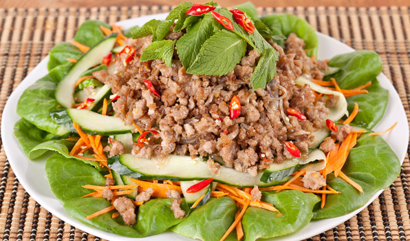 in the kitchen with stefano faita thai pork salad garnished with many mint leaves