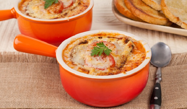 in the kitchen with stefano faita cheesy tomato soup in an orange bowl with a spoon