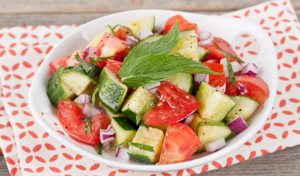 in the kitchen with stefano faita fresh tomato and cucumber salad served in a white bowl with mint leaf as garnish