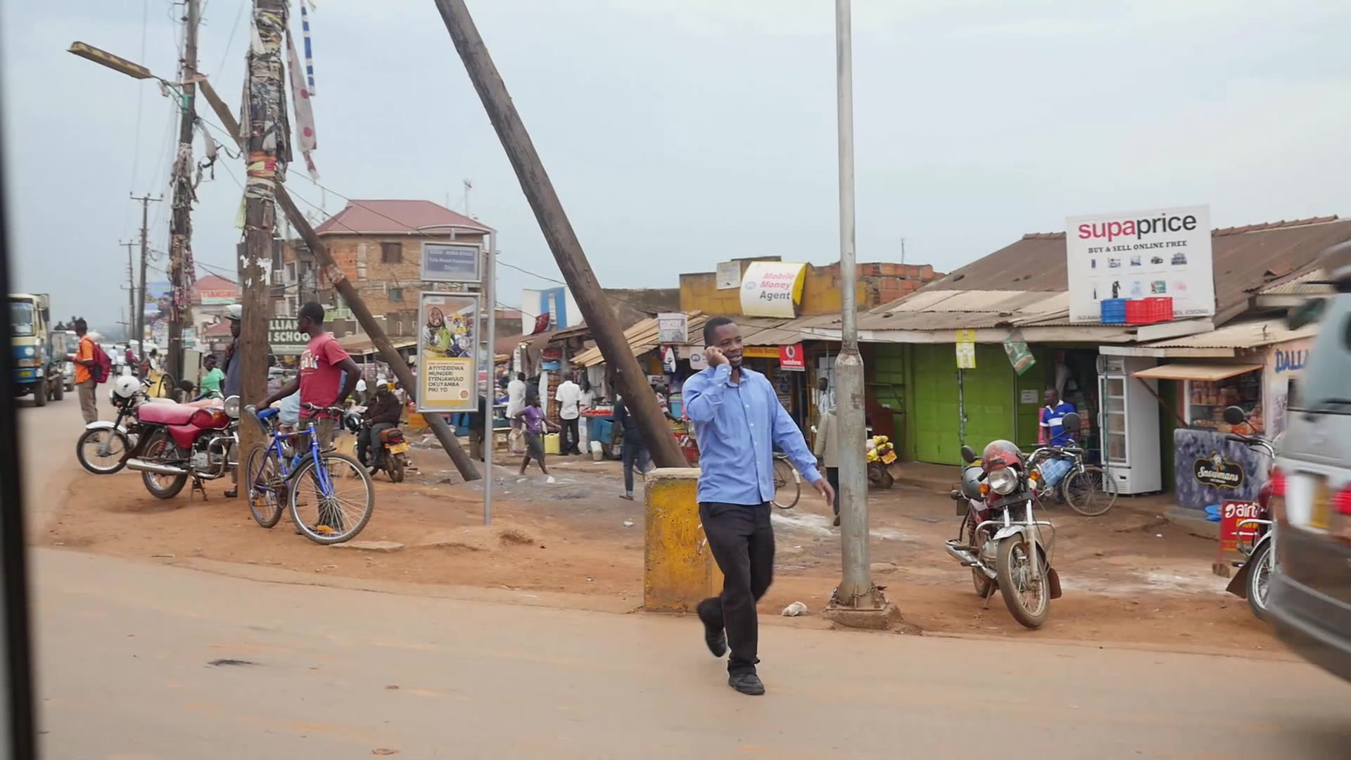 A MAN TALKING BY PHONE AND WALKING