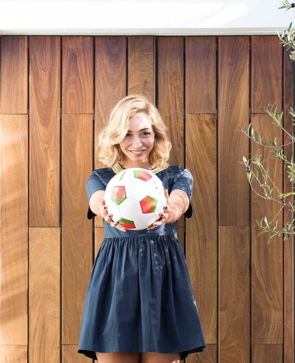 host poses with soccer ball