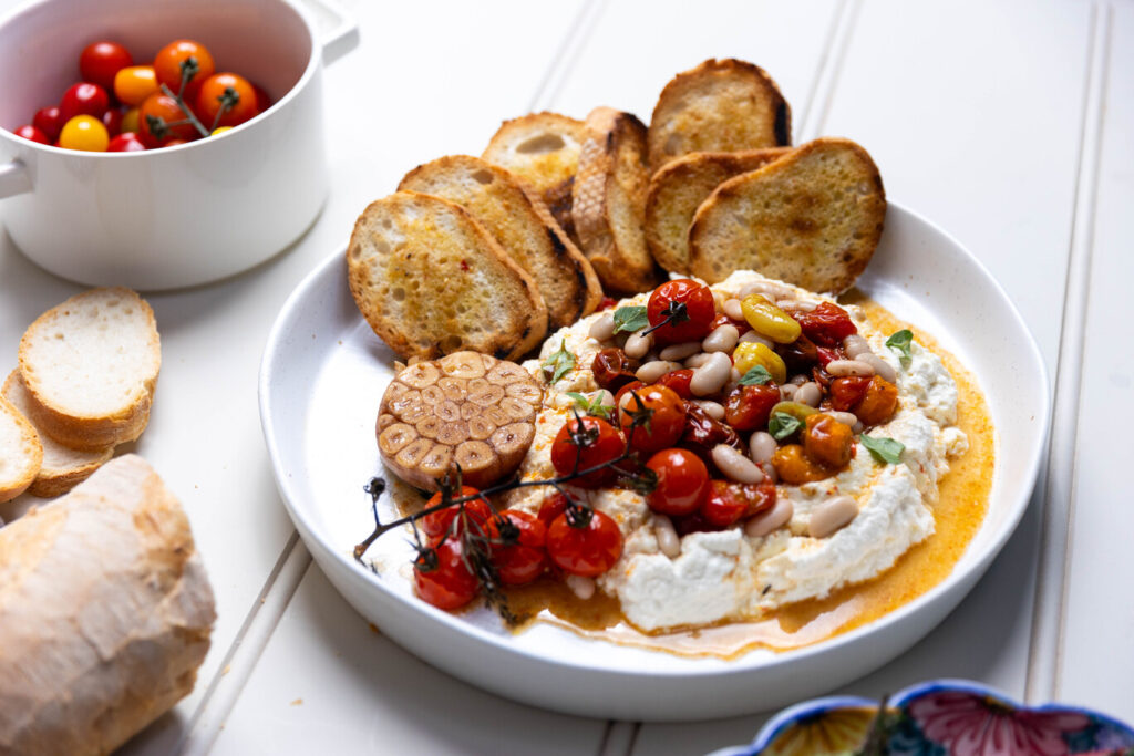 Crostini with roasted tomatoes, cannellini beans and whipped ricotta